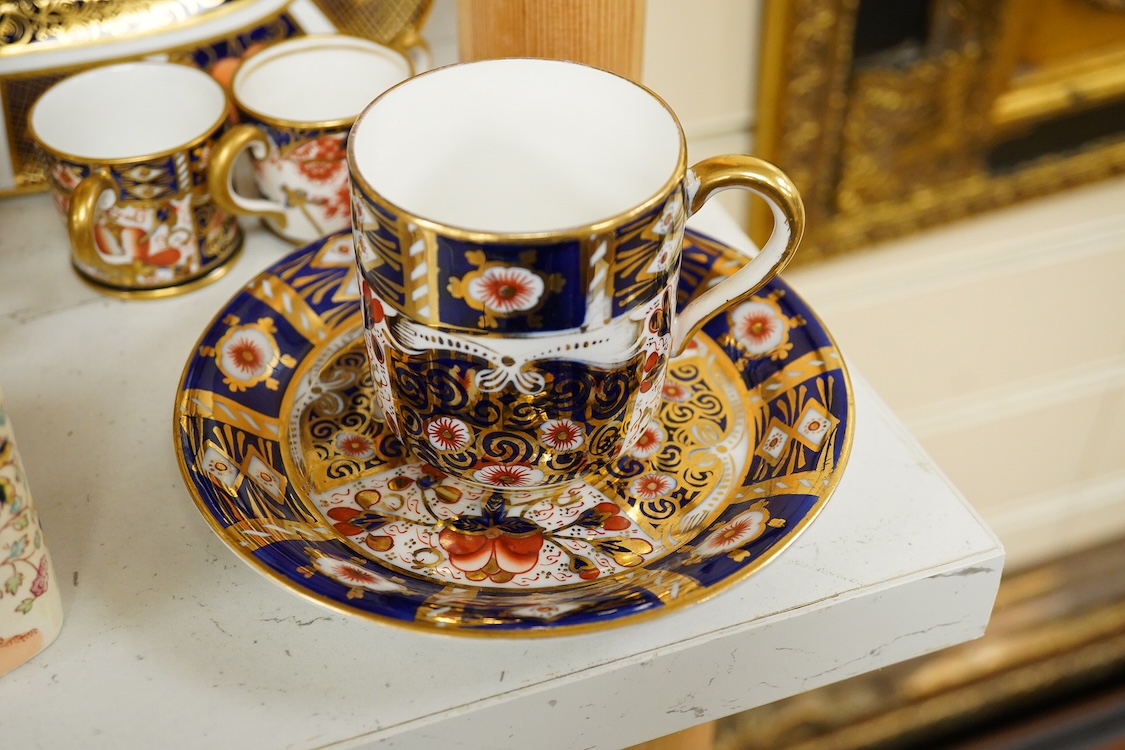 A quantity of Royal Crown Derby Imari to include a sandwich plate, cups and saucers and and miniature twin handled cups, largest 27cm in diameter